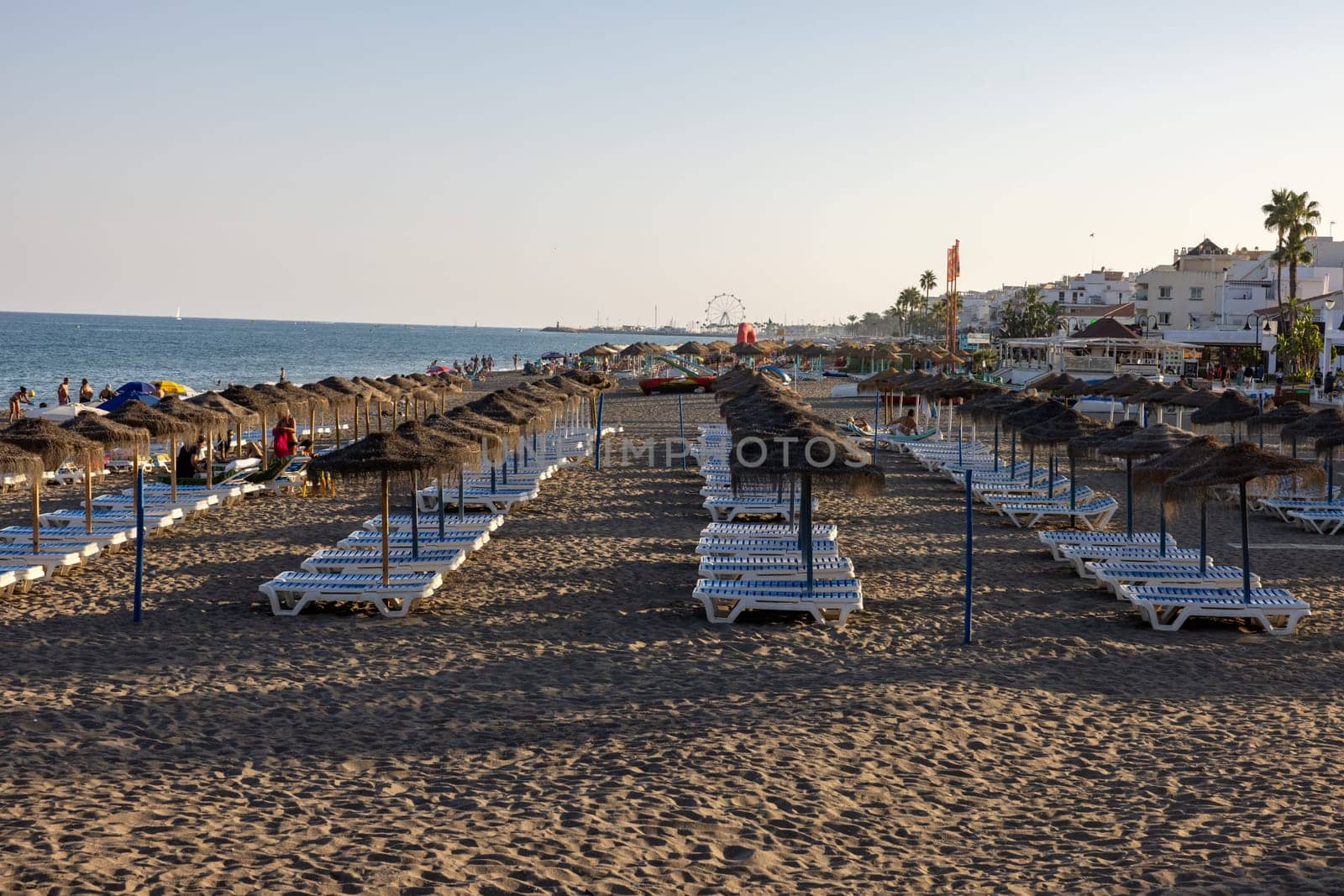 Torremolinos, Spain - September 9, 2023: People relaxing on La Carihuela beach in Torremolinos, Malaga, Costa del Sol, Spain