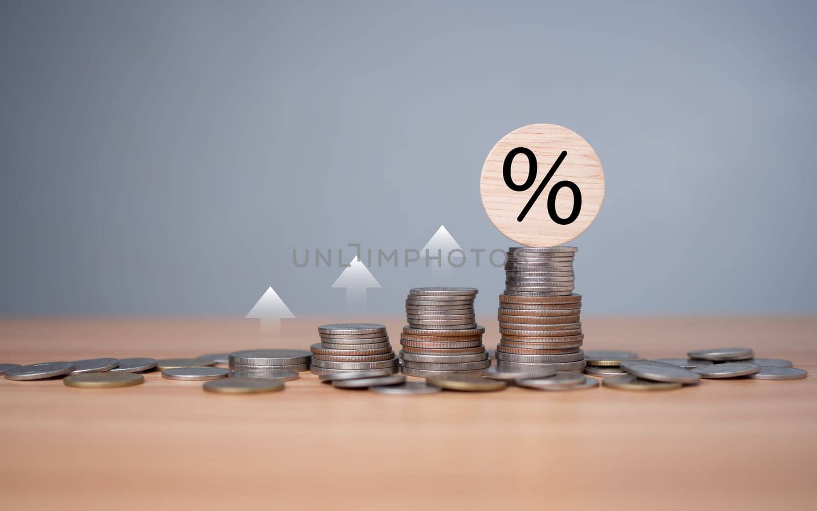 Percent sign on a wooden cube with row of coins in idea for FED consider interest rate hike, inflation concept, white graph arrow, world economics, and inflation control, Money and budget management