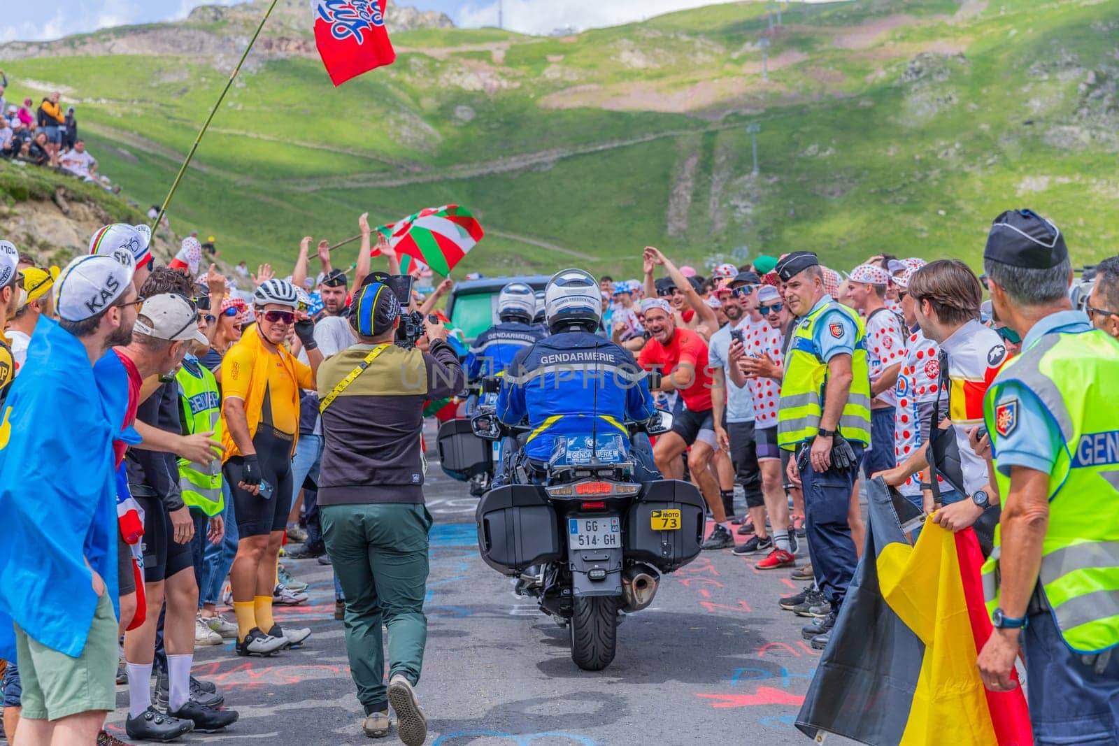 Col du Tourmalet, France - July 06 2023: Cycling fans waiting for the buch at the top of the Col du Tourmalet in Pyerenees mountains during the stage 6 of Le Tour de France 2023