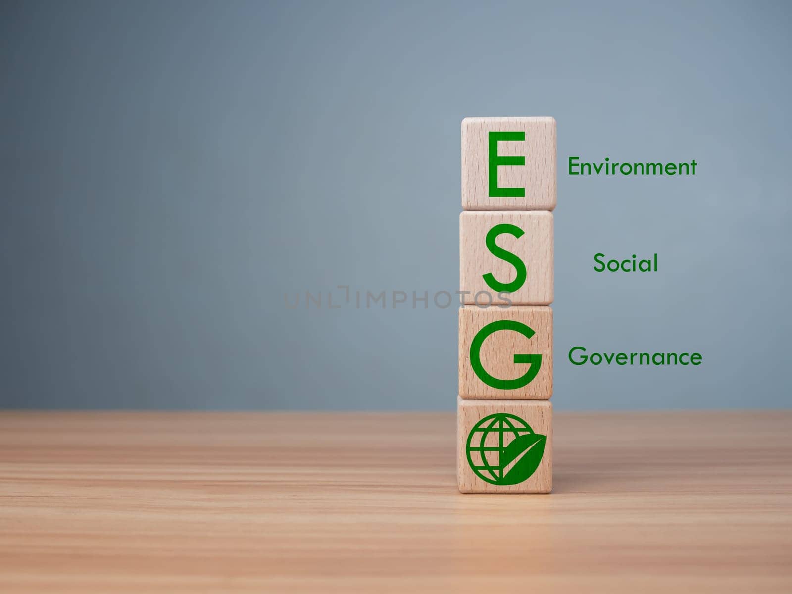 ESG concept of environmental, social and governance, wood block and icon on wooden background It is an idea for sustainable organizational development ​account the green environment.
