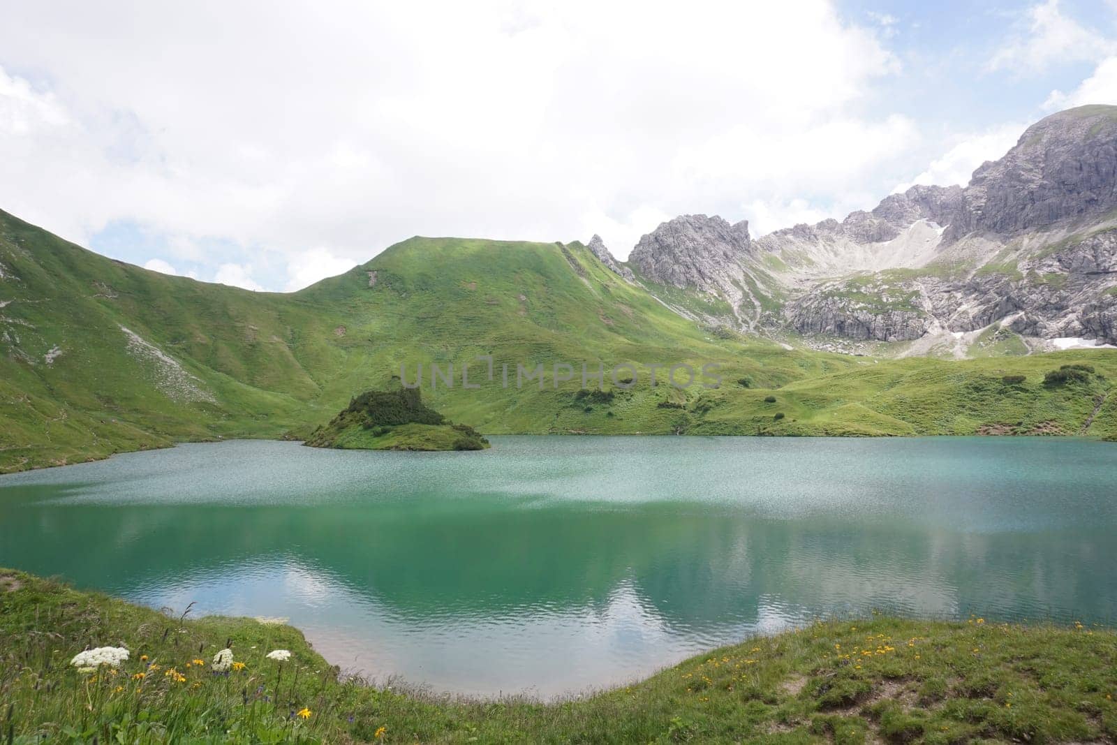 The beautiful lake Schrecksee in the german Alps with its Island and surrounding mountains, Allgäu, Germany 2020