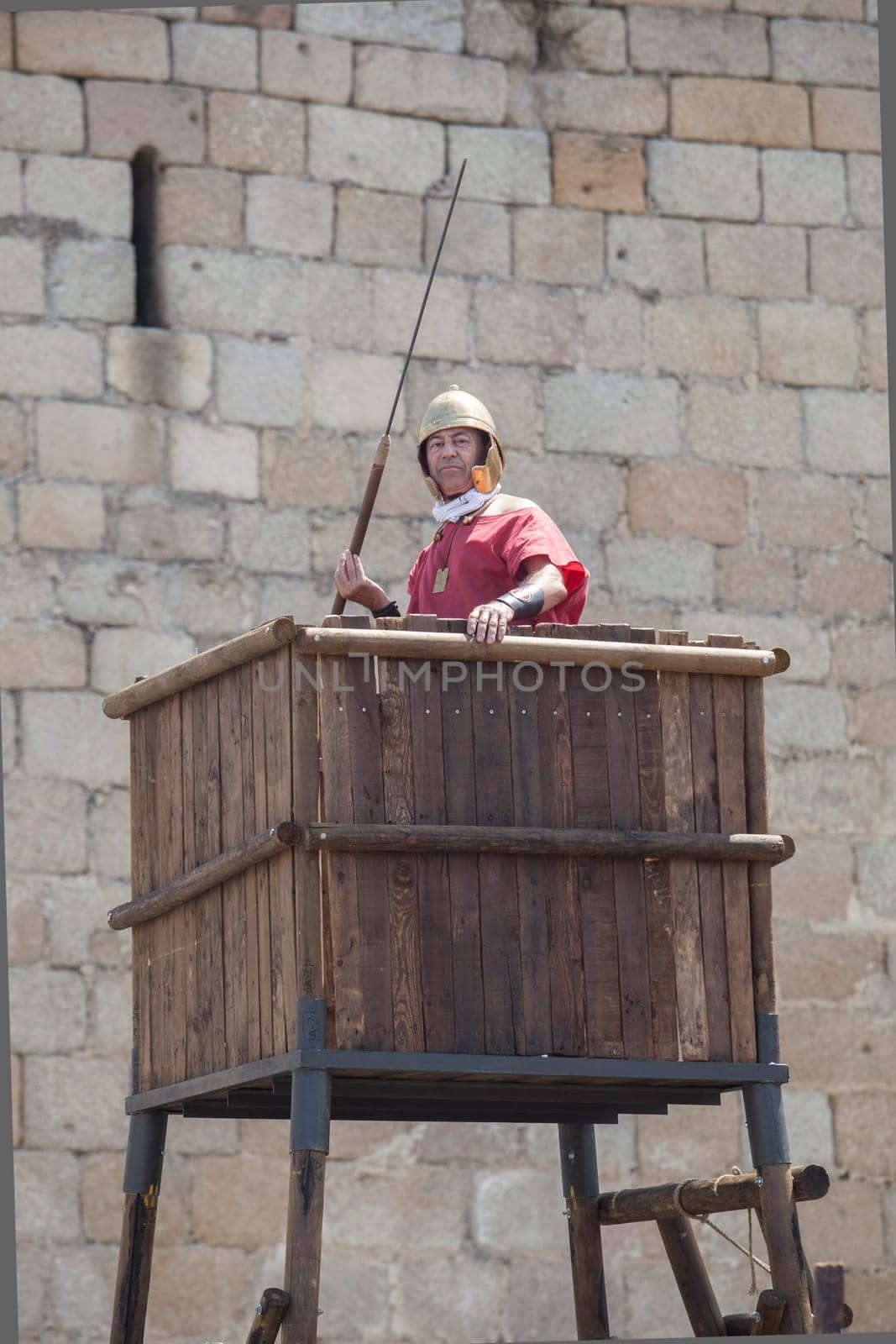 Merida, Spain - June 4h, 2023:  Reenactor over watchtower of a roman camp. Emerita Ludica Festival 2023, Merida, Spain