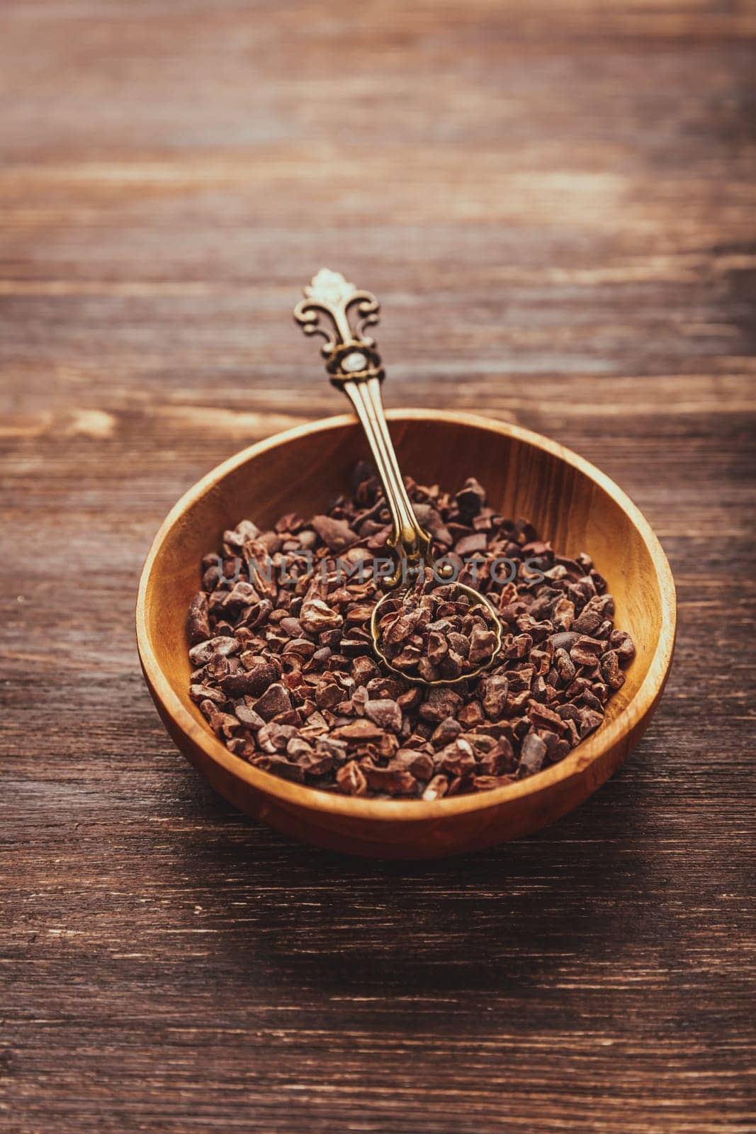 Cocoa bean nibs  in small bowl - baking ingredients
