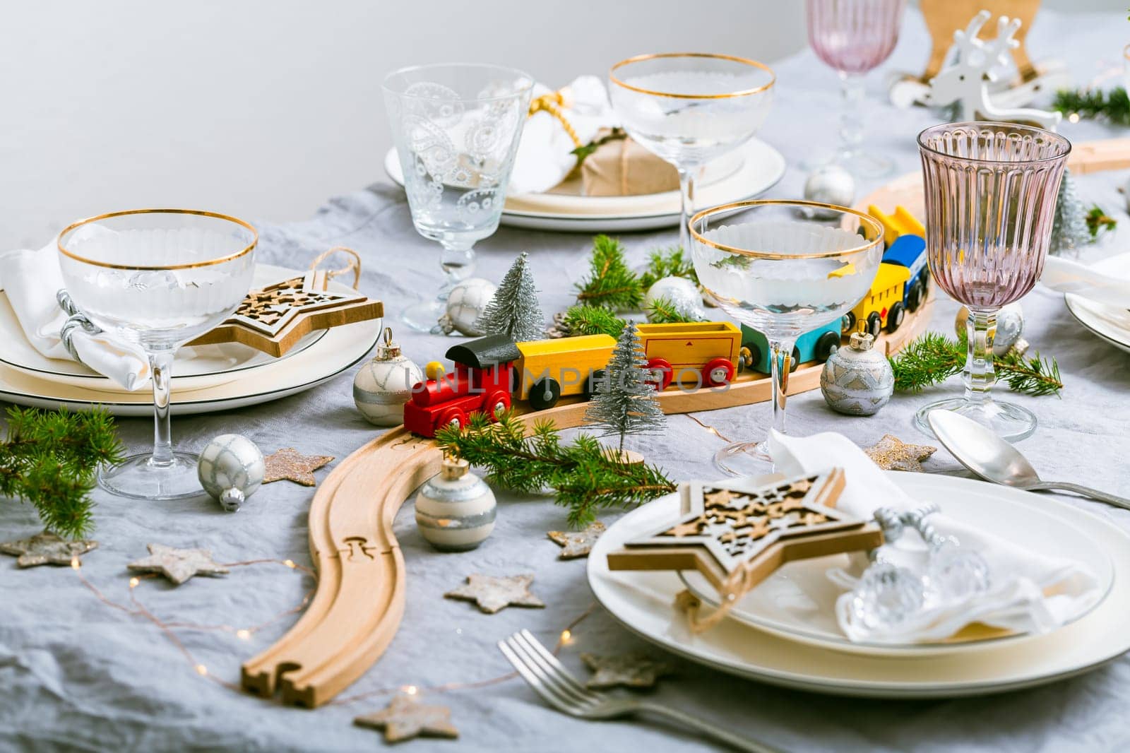 Festive Chriustmas place setting with small wooden railway
