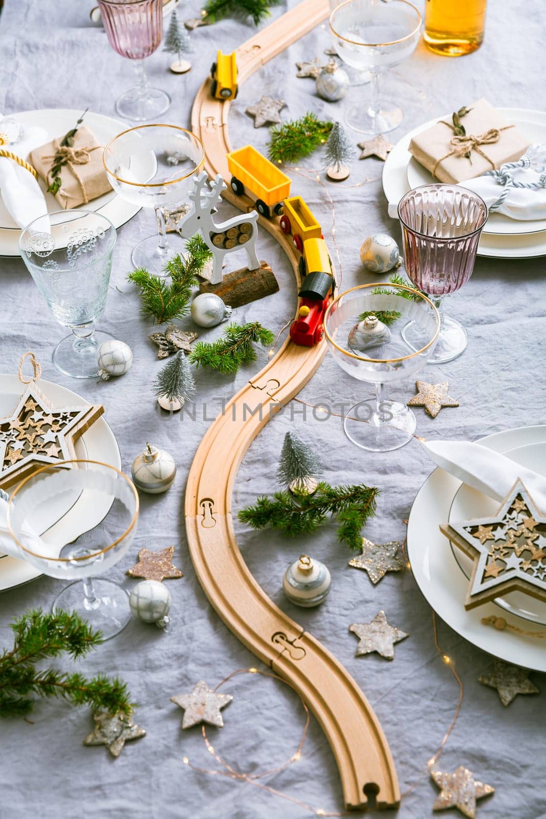 Festive Christmas place setting with small wooden railway