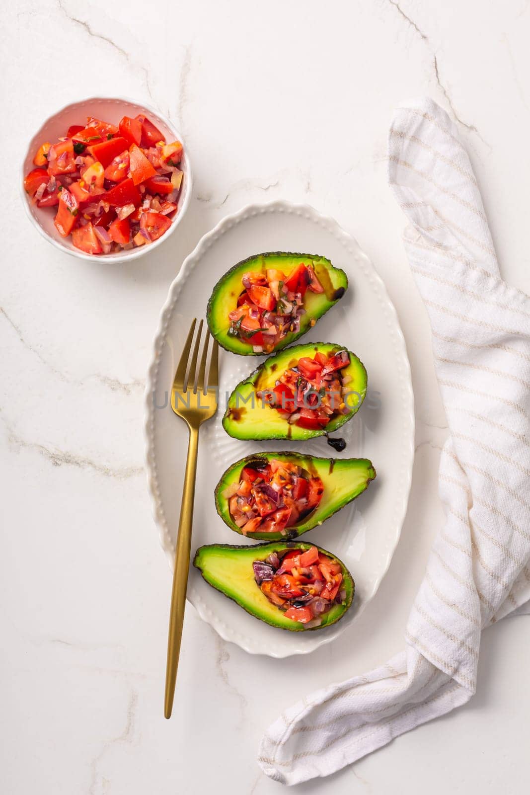 Avocados filled with bruschetta and balsamic vinaigrette - vegan appetizers