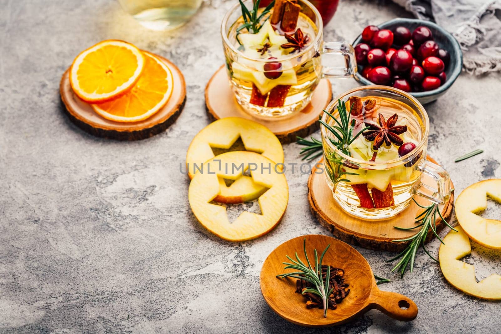 Delicious white mulled wine with apples, cranberries and spices