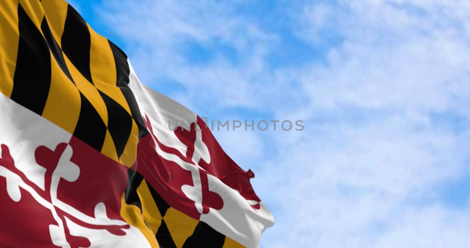 Maryland state flag waving on a clear day. Four quadrants with the colors of the Calvert and Crossland families. 3d illustration render. Fluttering fabric. Selective focus