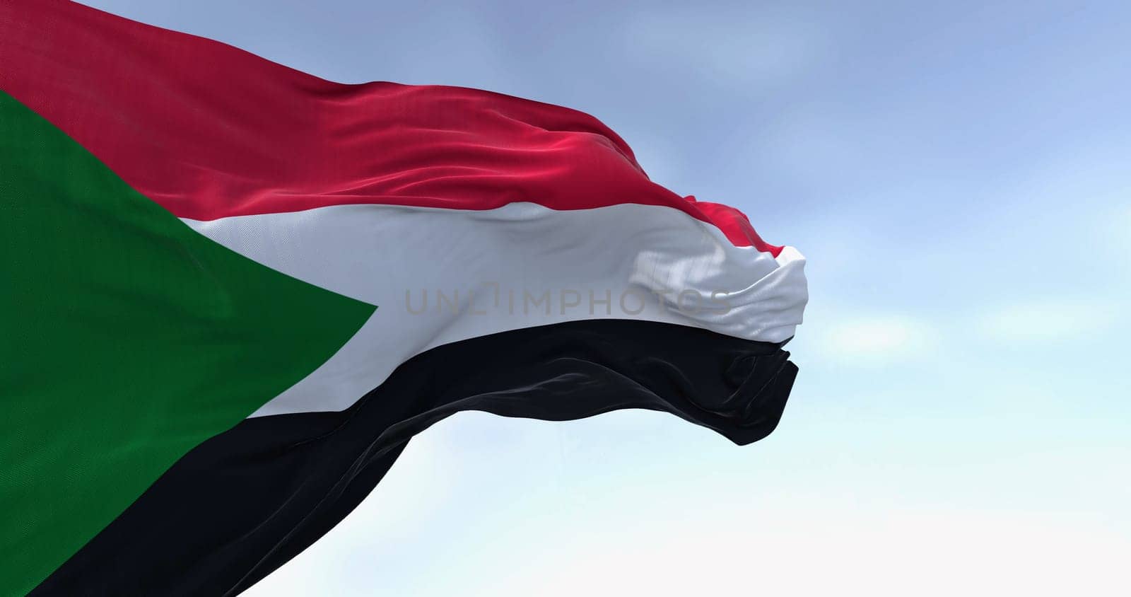 Close-up of Sudan national flag waving in the wind. Red, white, black horizontal stripes with a green triangle at the hoist. 3d illustration render. Rippling fabric