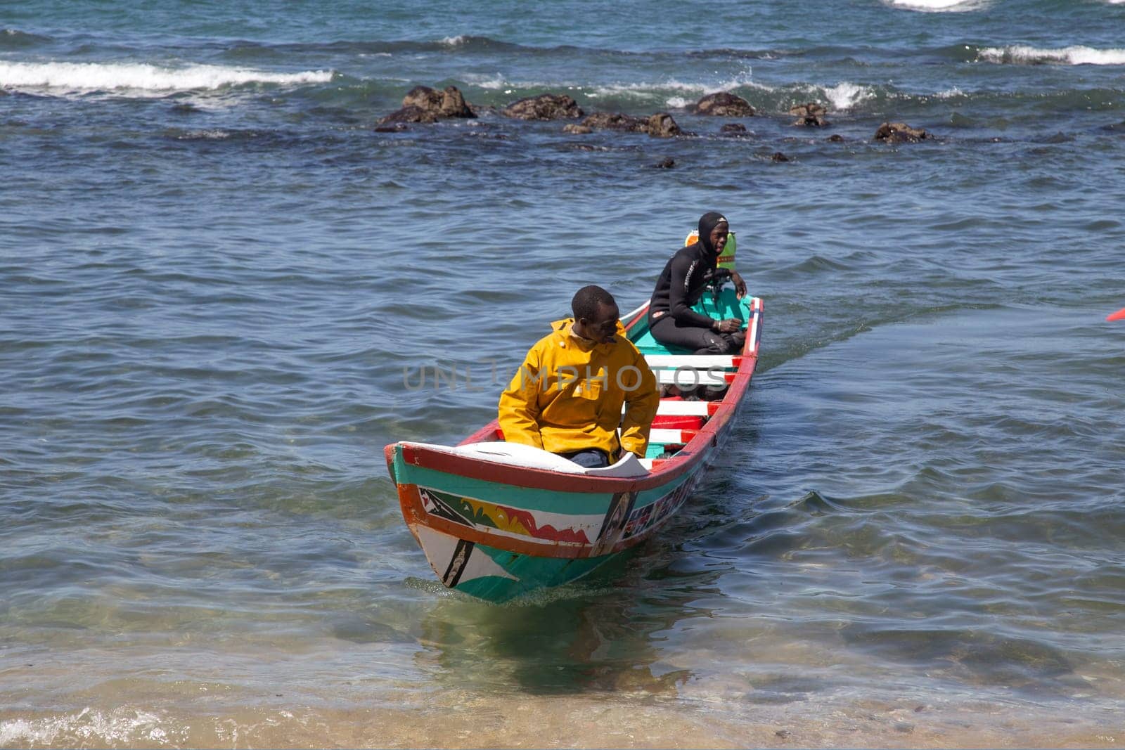 Dakar, Senegal. August 18, 2019: Fishermen with a fishing boat in a beach at Dakar, one of the many fishing beaches of Dakar, Senegal, West Africa