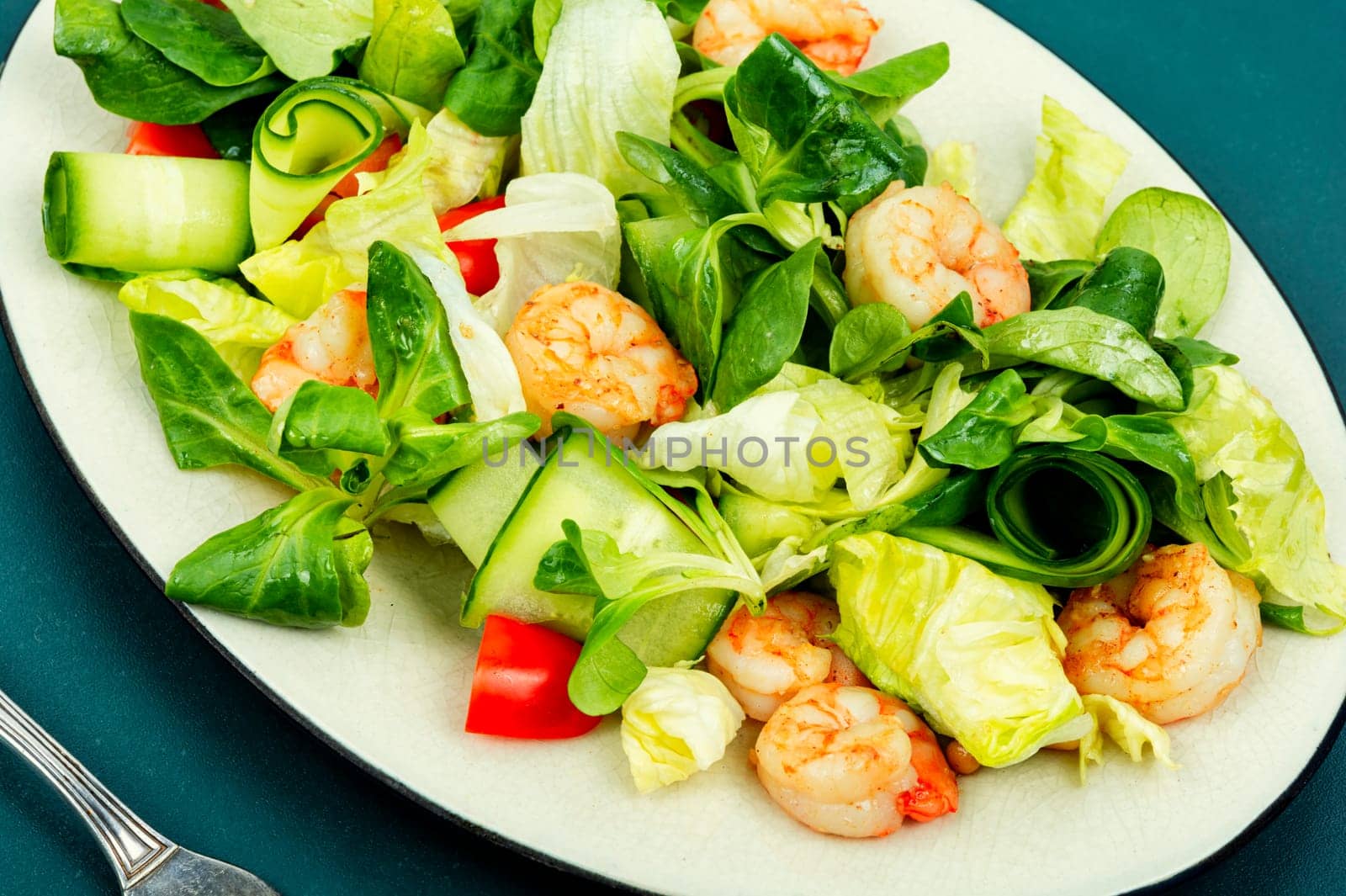 Plate with salad of fresh vegetables, mixed greens and shrimp. Prawns salad. Clean food, top view, copy space.