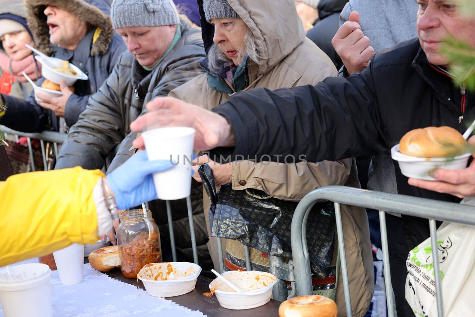 Krakow, Poland - Dec 17, 2023: Christmas Eve for poor and homeless on the Main Square in Cracow. The group Kosciuszko prepares the greatest eve in the open air in Krakow