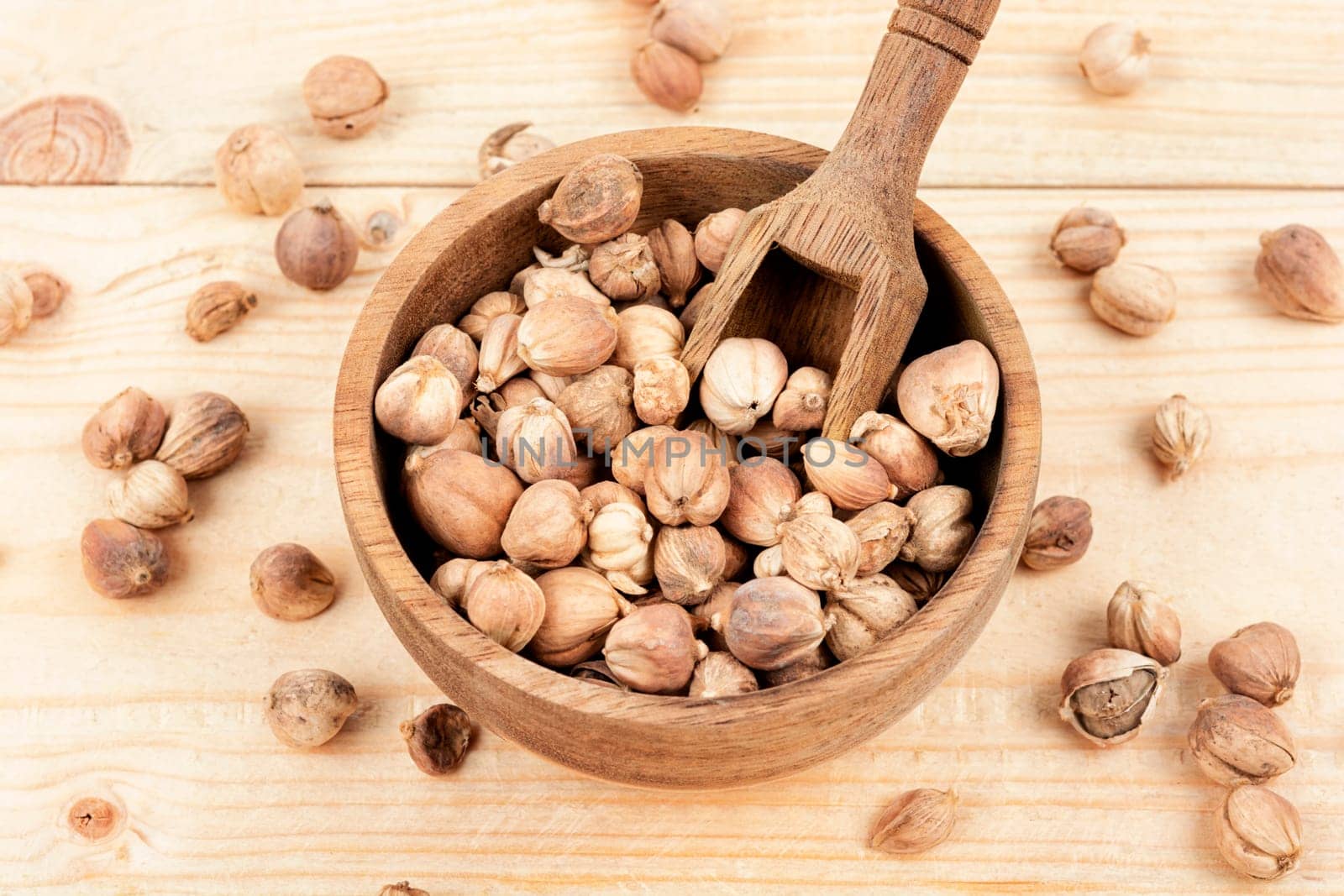 White dried cardamom pods in a wooden bowl and knife, spice.