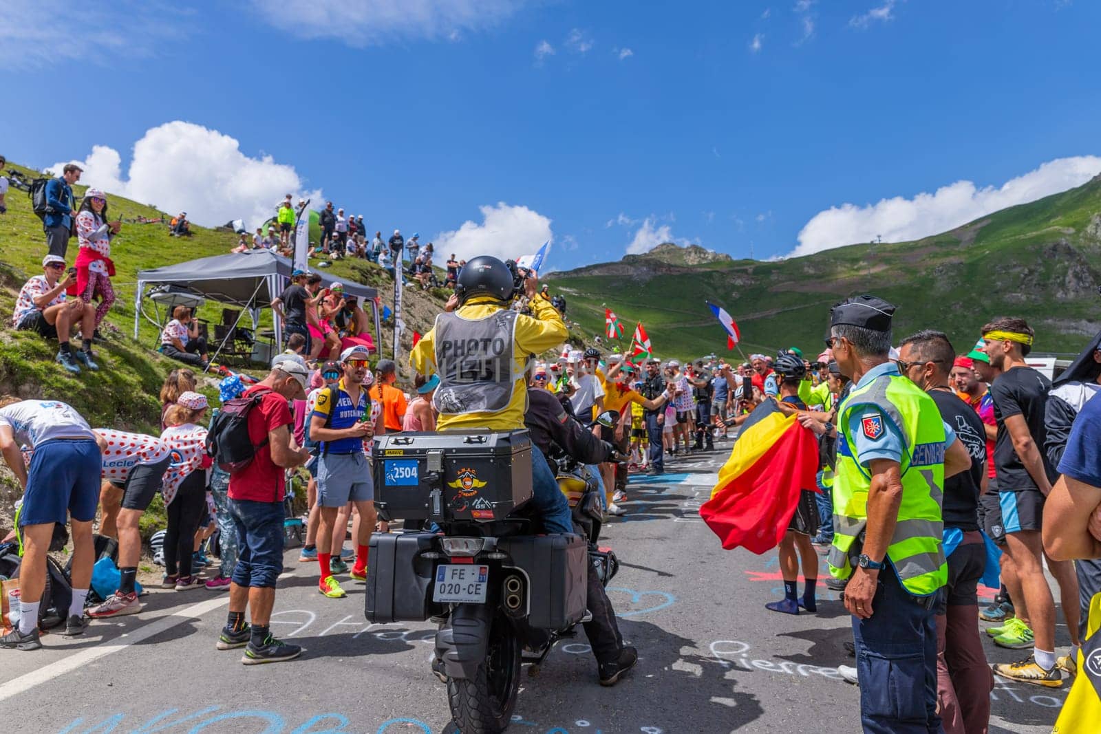 Col du Tourmalet, France - July 06 2023: Cycling fans waiting for the buch at the top of the Col du Tourmalet in Pyerenees mountains during the stage 6 of Le Tour de France 2023