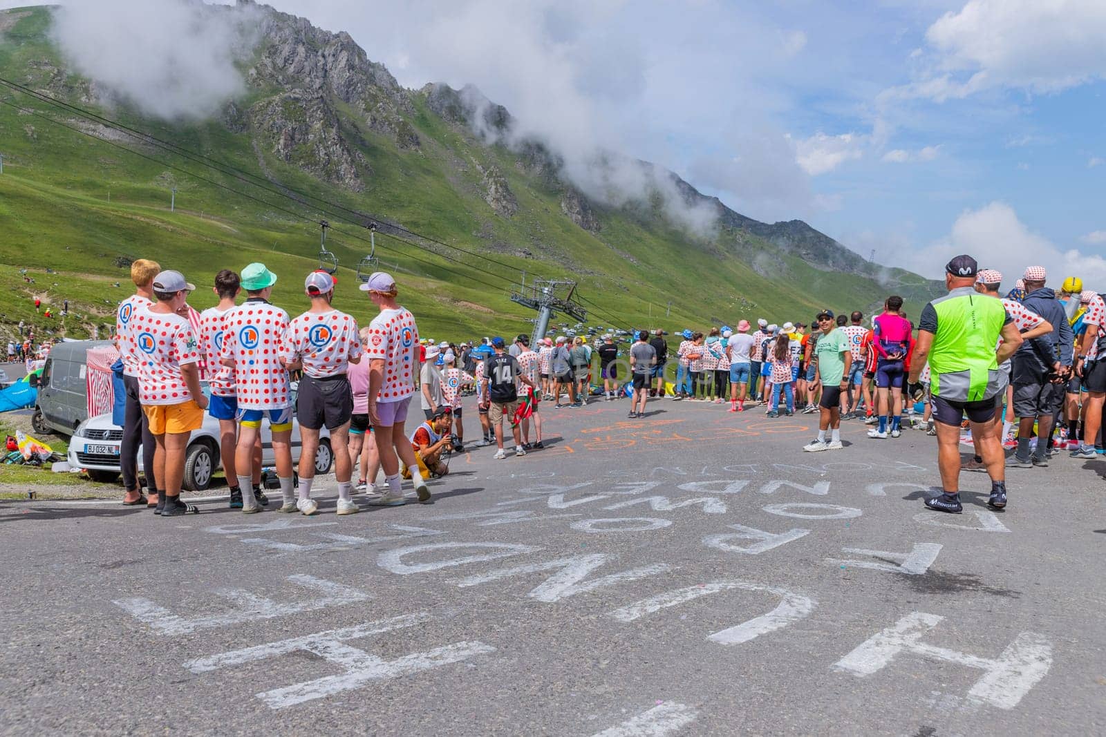 Col du Tourmalet, France - July 06 2023: Cycling fans waiting for the buch at the top of the Col du Tourmalet in Pyerenees mountains during the stage 6 of Le Tour de France 2023
