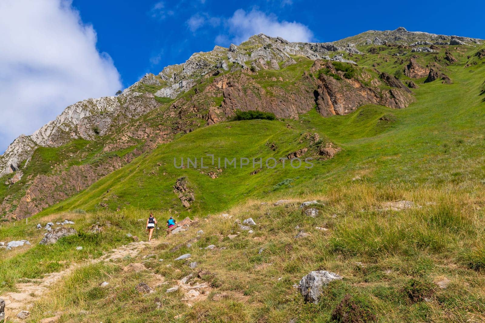 Asturias, Spain: 19 July 2023: Pilgrims on the Camino de Santiago (The Way of Saint James) among the fog morning light at the mountains. Primitivo. Asturias, Spain