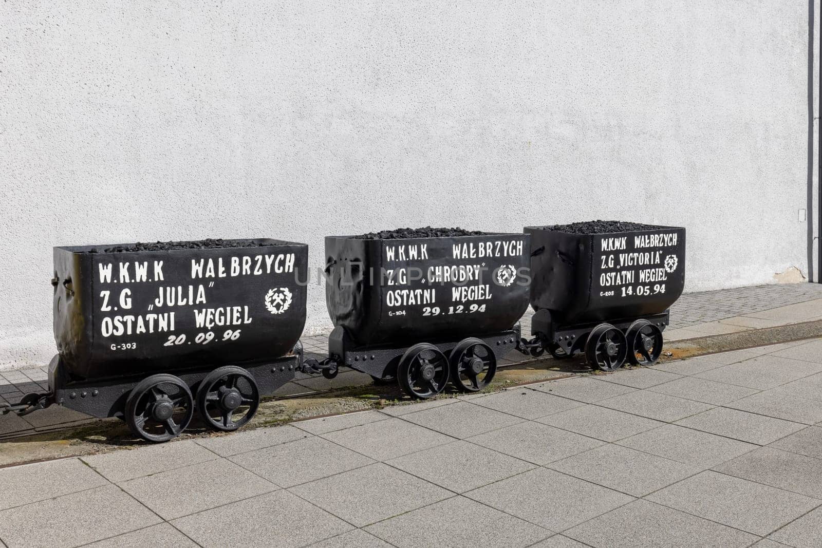Walbrzych, Poland - October 1, 2021: The Old Mine Science and Art Centre, museum located in the historic Julia Coal Mine. Wagons with the last load of coal before closing the mine