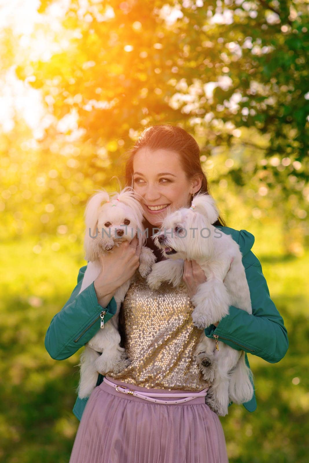 Young girl with her dog. Puppy white dog is running with it's owner. Conception about friendship, animal and freedom.