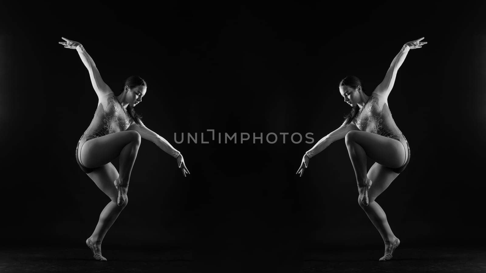 Beautiful ballet dancer sport aerobics female posing on a white and black studio background