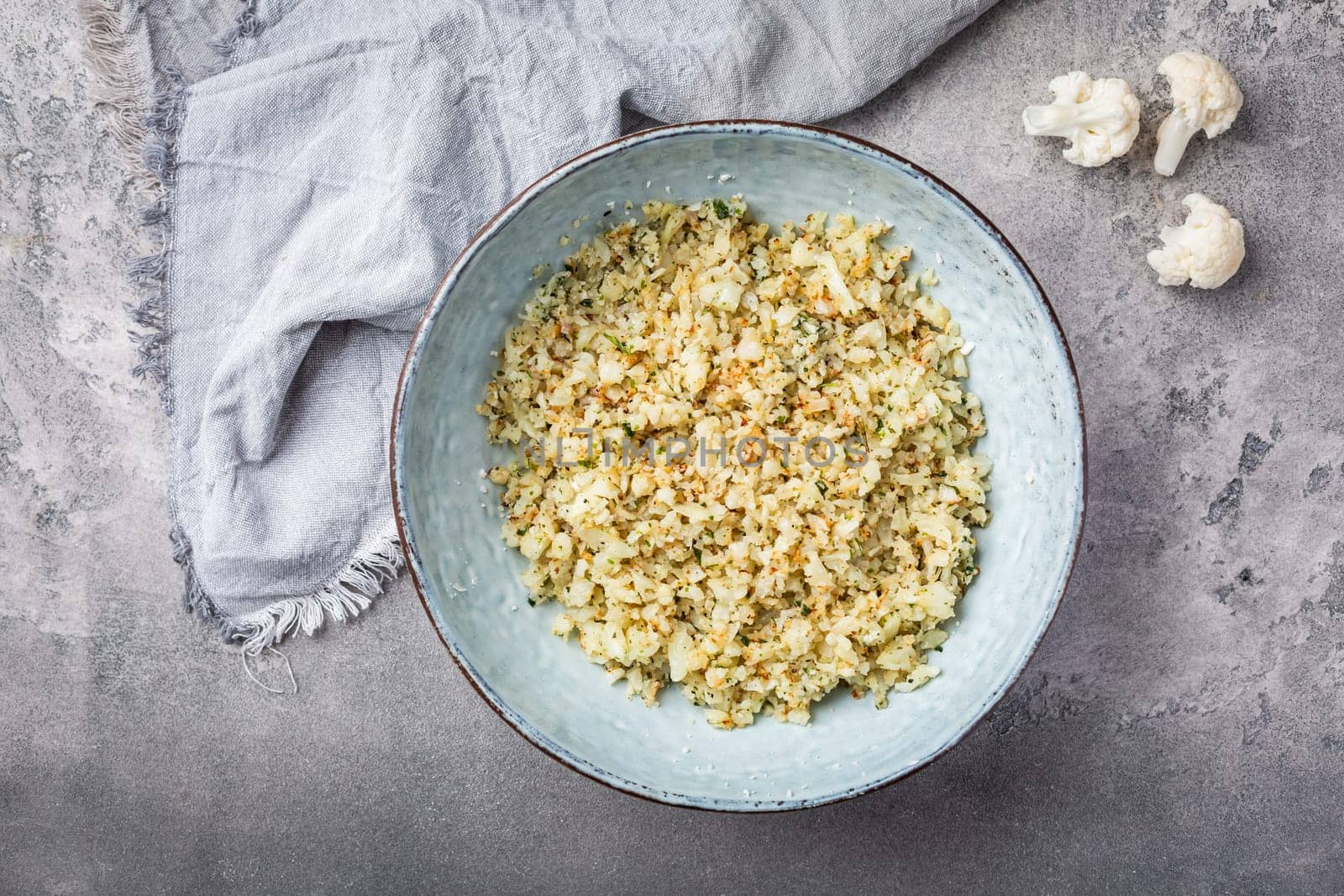 Roasted  organic cauliflower rice with herbs - paleo and ketogenic diet concept