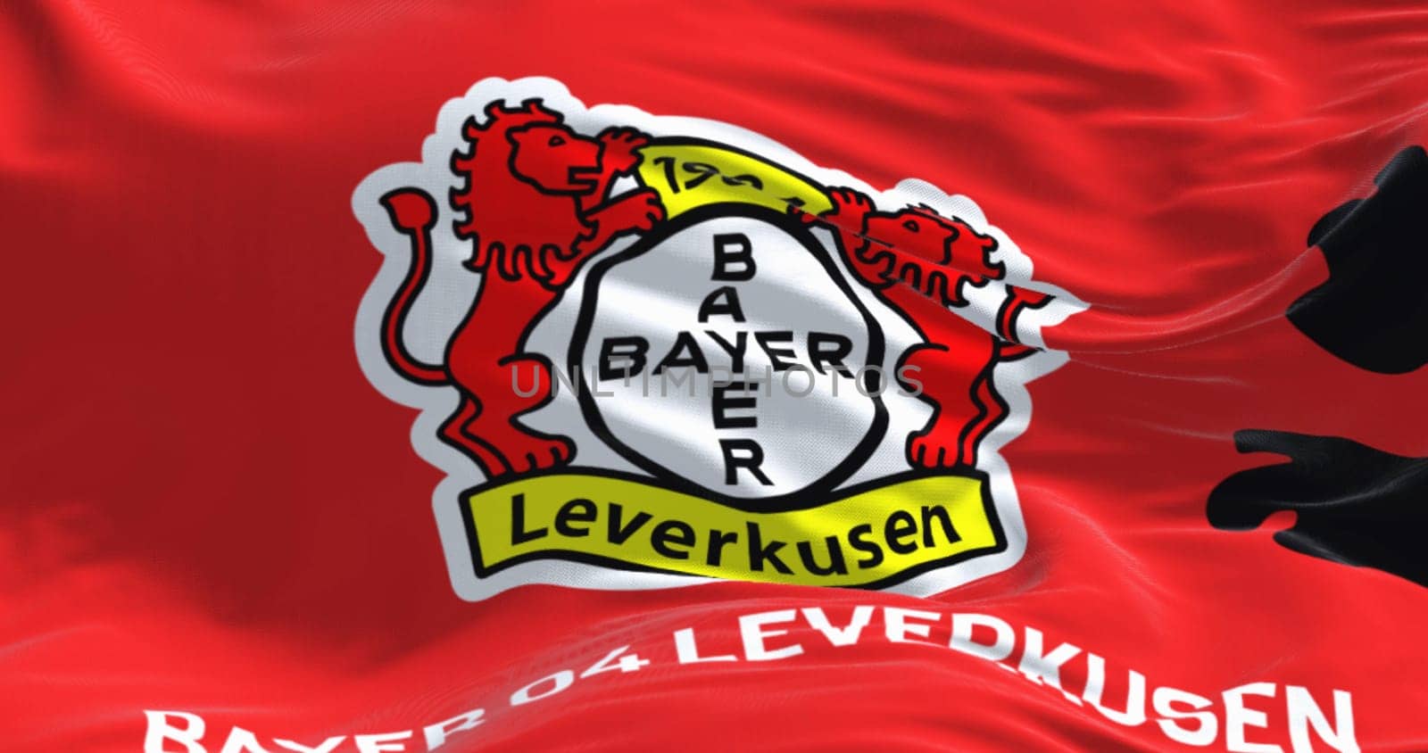 Leverkusen, DE, Nov. 2 2023: Close-up of Bayer Leverkusen flag waving. illustrative editorial 3d illustration render. Fluttering fabric. German Bundesliga Football club