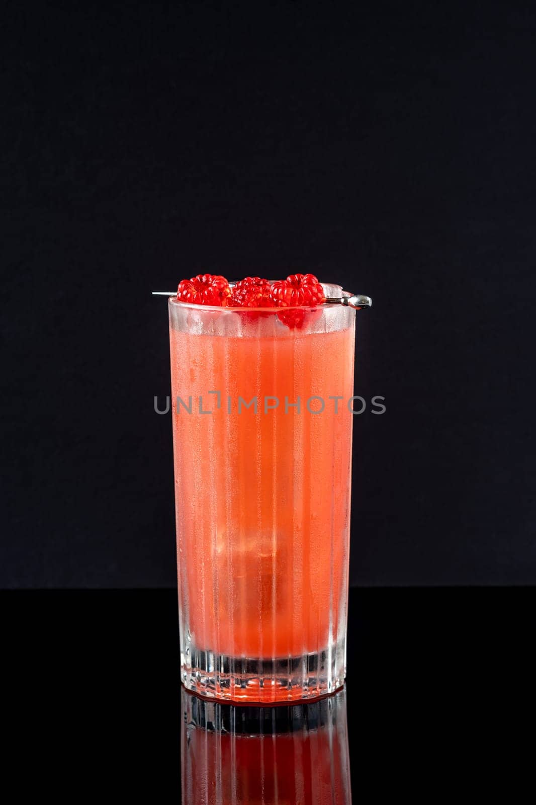 Prince of Wales Punch cocktail garnished with raspberries