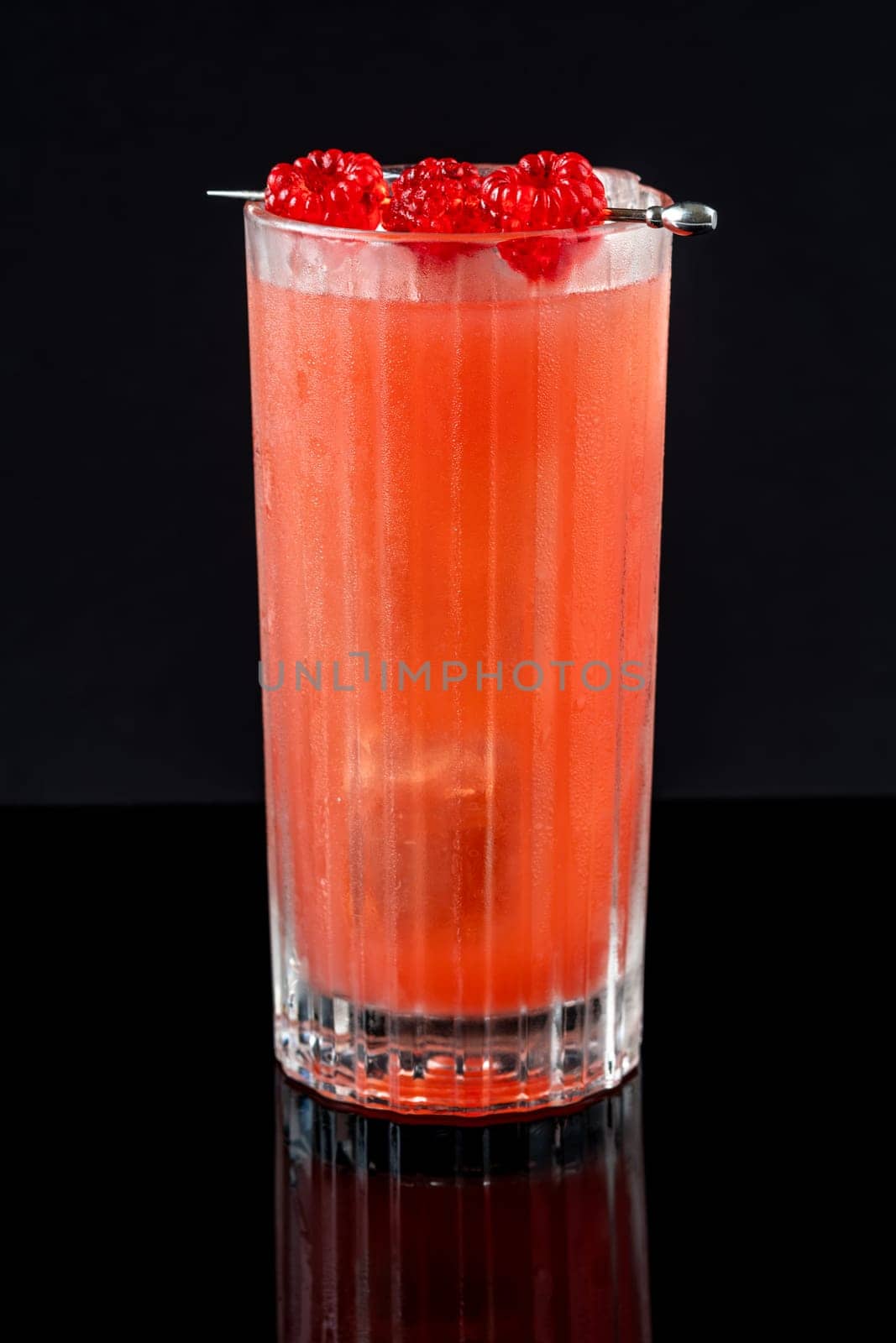 Prince of Wales Punch cocktail garnished with raspberries