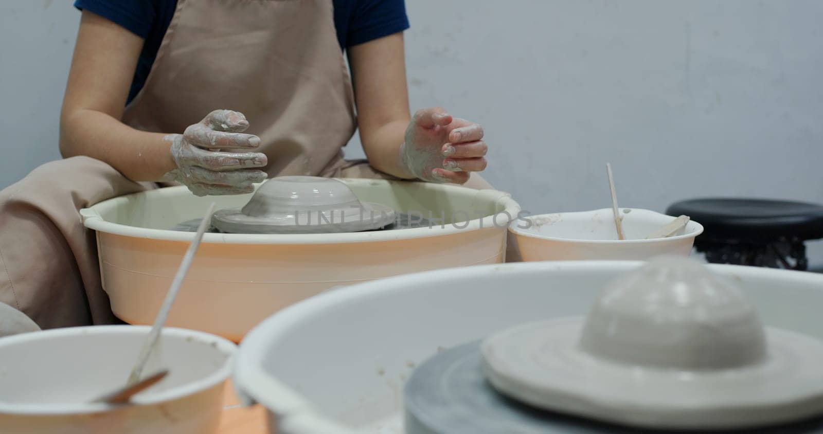 Hand work on pottery wheel, shaping a clay pot