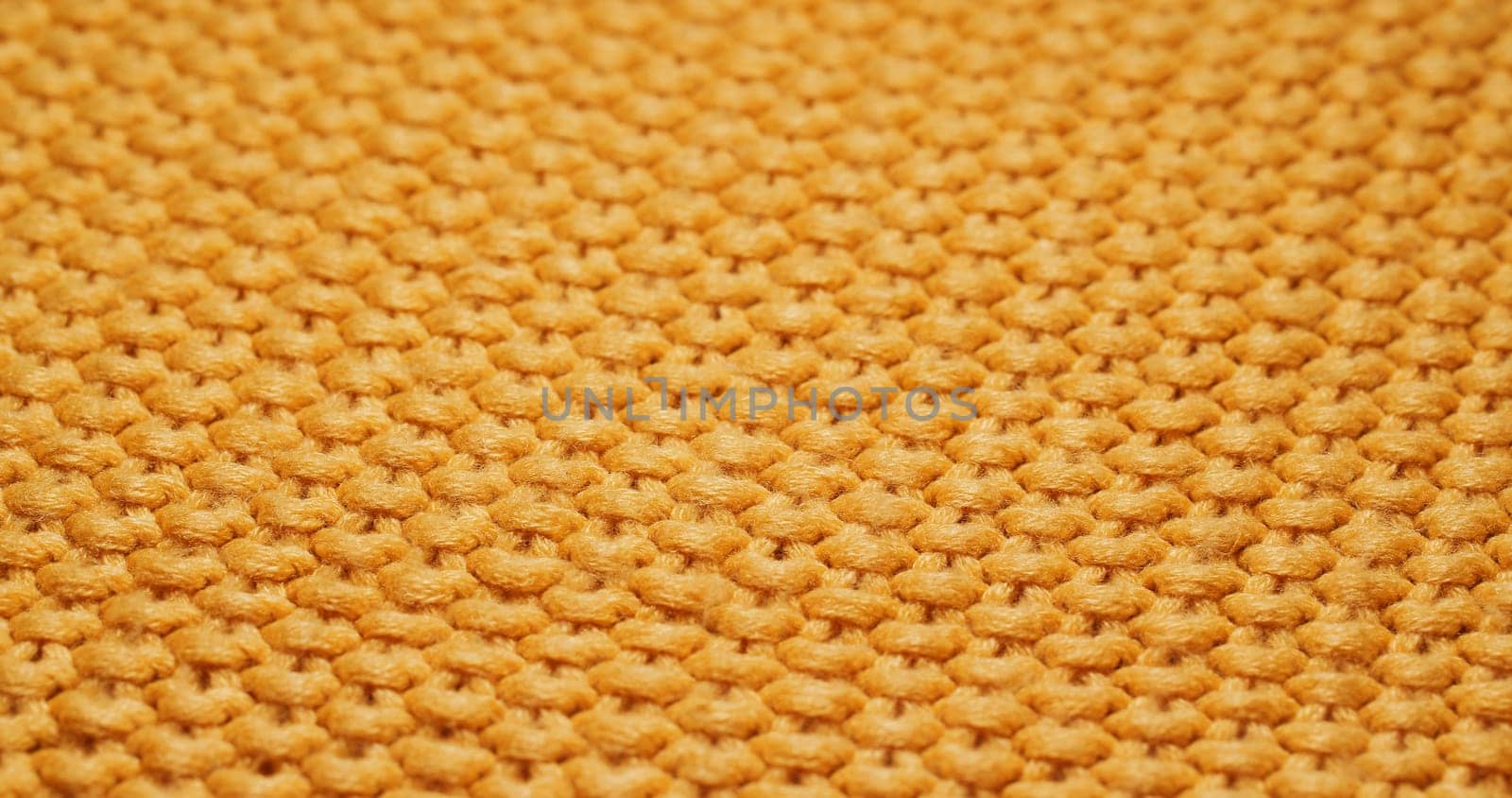 Yellow knitted duvet texture close up