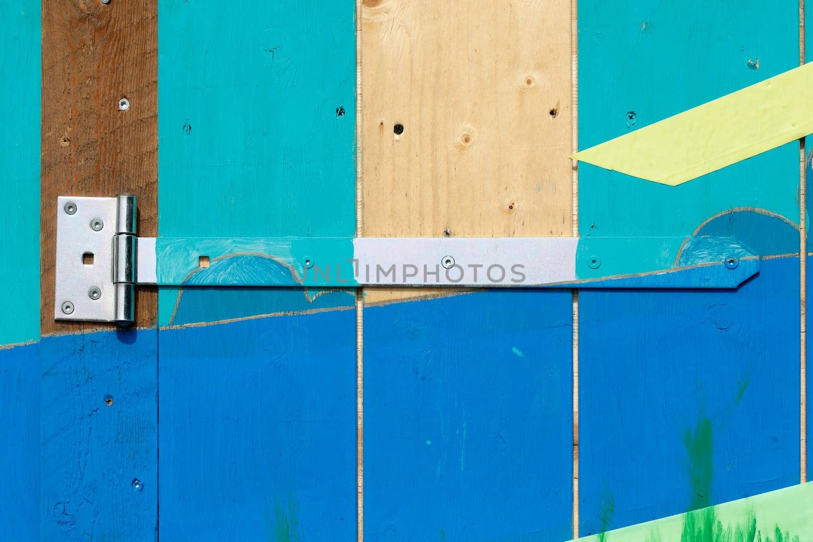 Hinge on a colorful wooden door, Germany