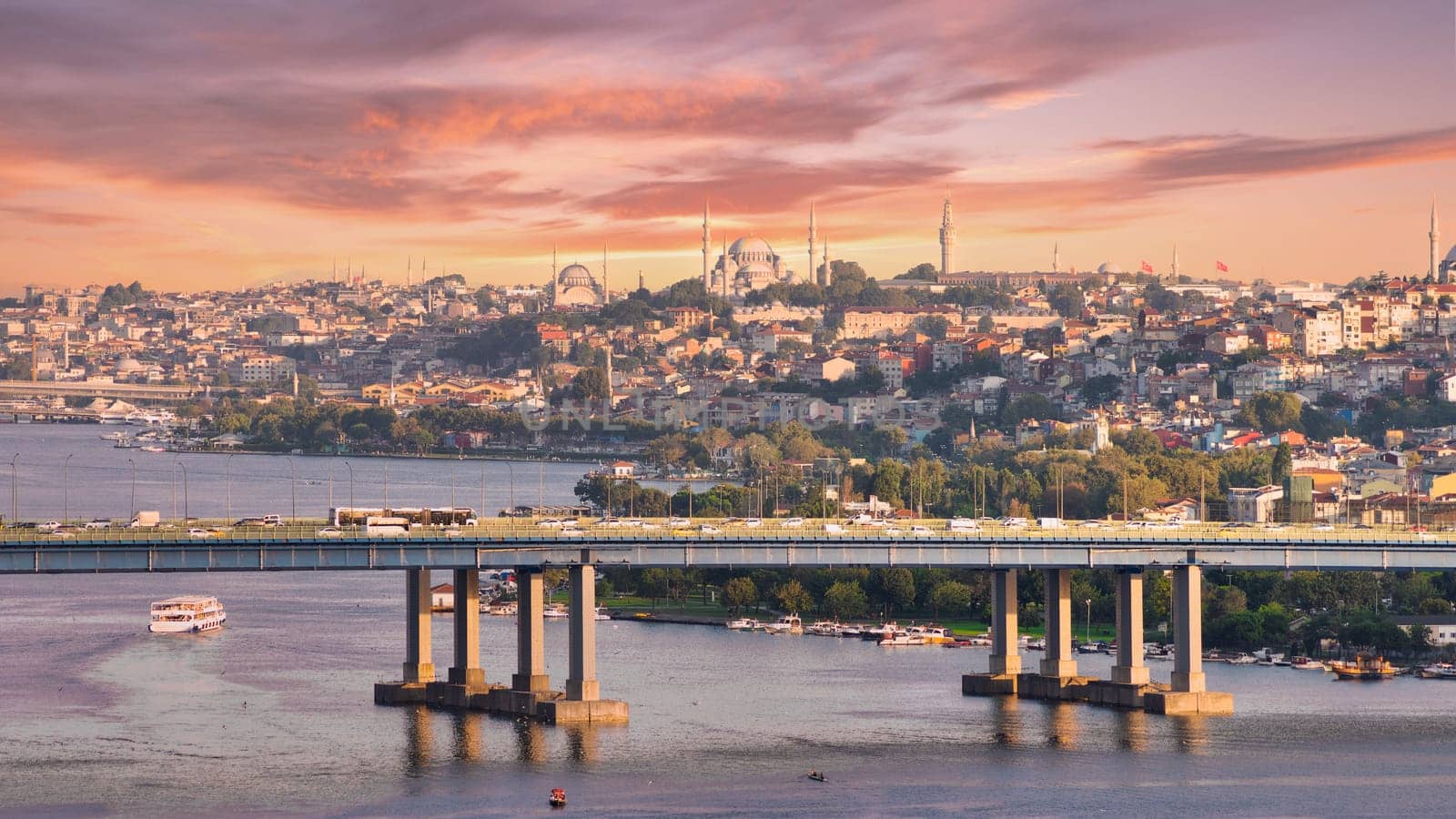 Aerial view from Pierre Loti popular hilltop park of the Halic Bridge, spanning the Golden Horn in Istanbul, Turkey, with background of city skyline, with historic mosques towering above the city