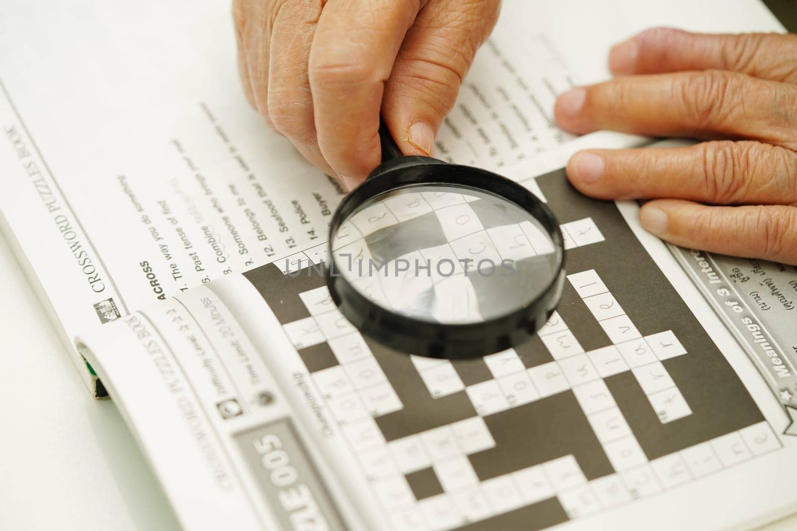 Bangkok, Thailand - May 15, 2022 elderly woman playing sudoku puzzle game for treatment dementia prevention and Alzheimer disease.