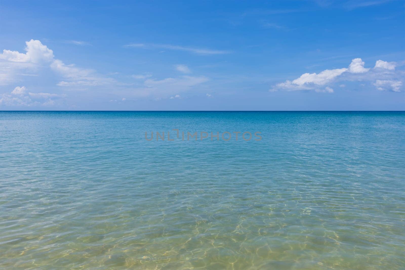 Clear water sand beach and blue sky