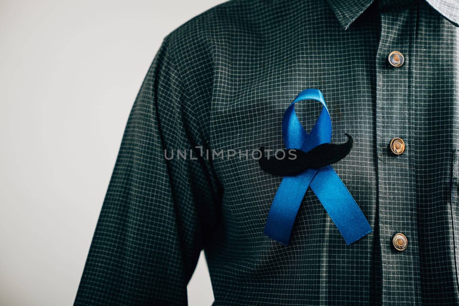 Men's hands exhibit a Blue Ribbon with a moustache, signifying solidarity and support for Colon cancer, Colorectal cancer, Child Abuse awareness, world diabetes day, and International Men's Day.