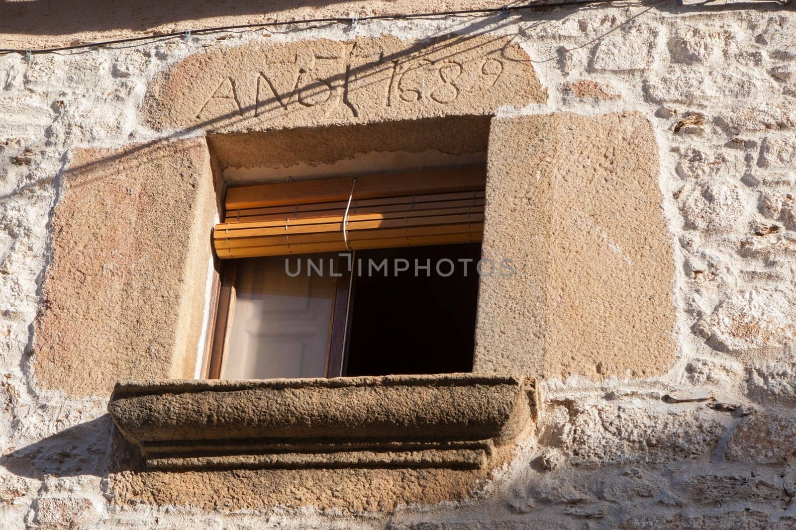 Window with lintel and carved granite sill. Perales del Puerto, beautiful little town in Sierra de Gata, Caceres, Extremadura, Spain