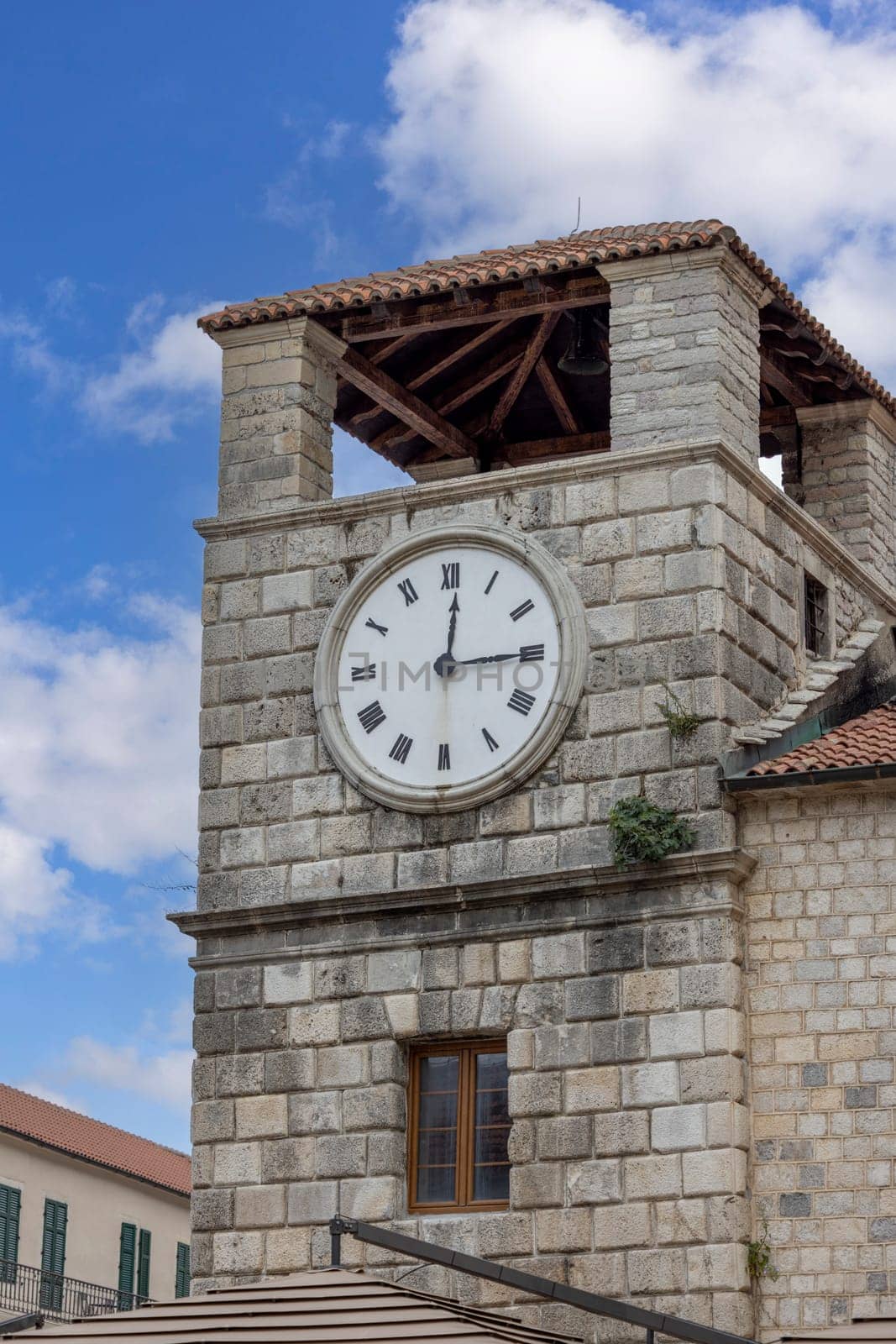Kotor, Montenegro - June 26, 2023: Medieval Clock Tower on Arms Square