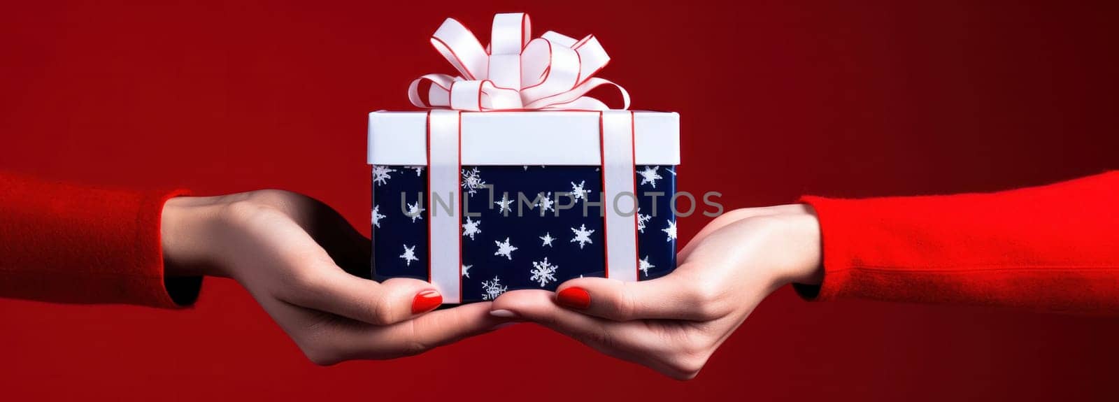 person holding a white christmas gift box on red background.