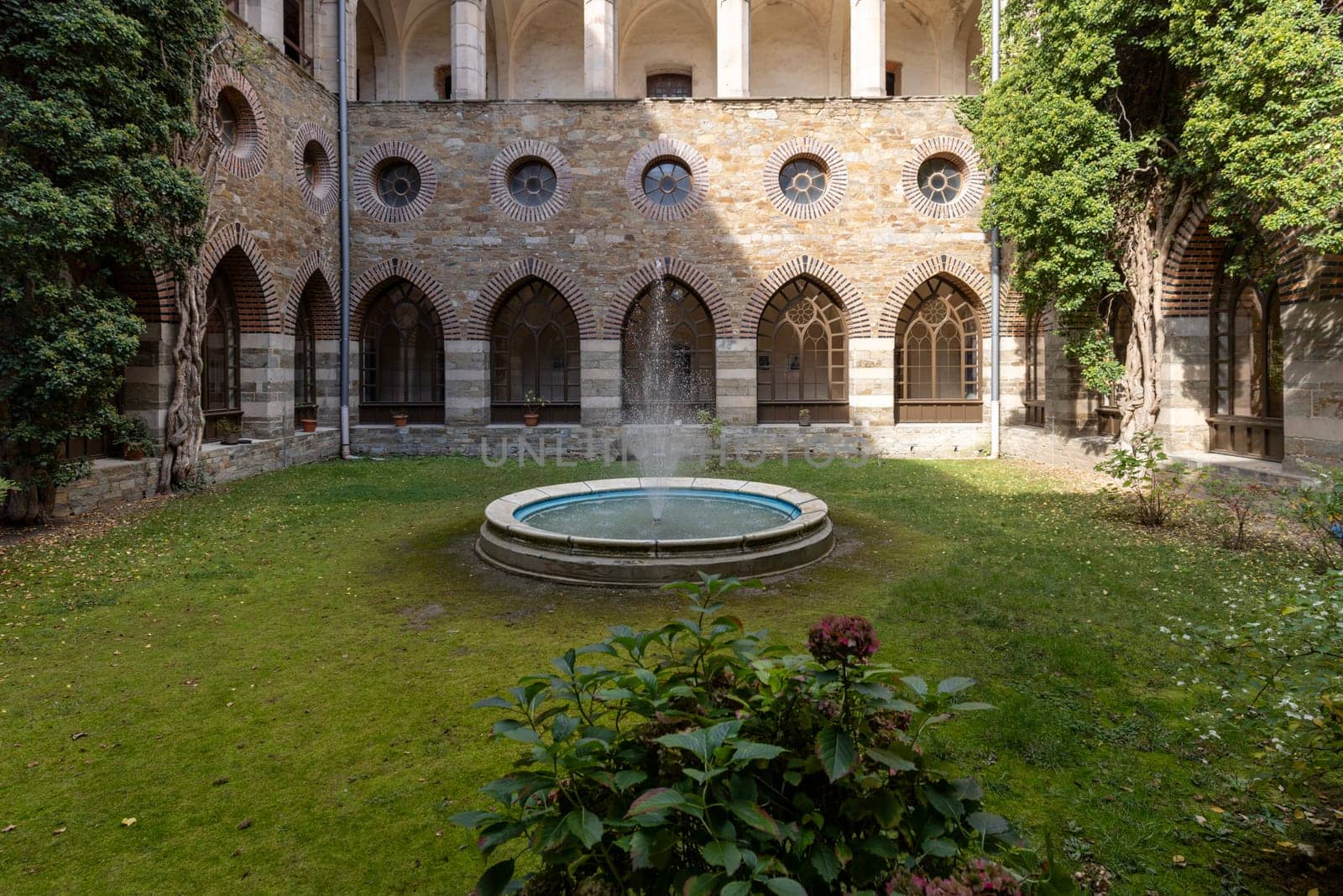 Kamieniec Zabkowicki, Poland - October 2, 2021: Kamieniec Zabkowicki Palace, 19th-century monumental palace located in a village in the Lower Silesian Voivodeship. Cloistered Courtyard  with fountain
