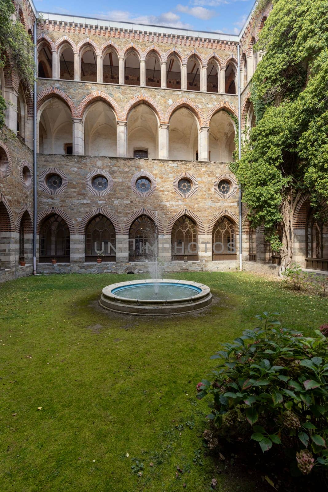 Kamieniec Zabkowicki, Poland - October 2, 2021: Kamieniec Zabkowicki Palace, 19th-century monumental palace located in a village in the Lower Silesian Voivodeship. Cloistered Courtyard  with fountain