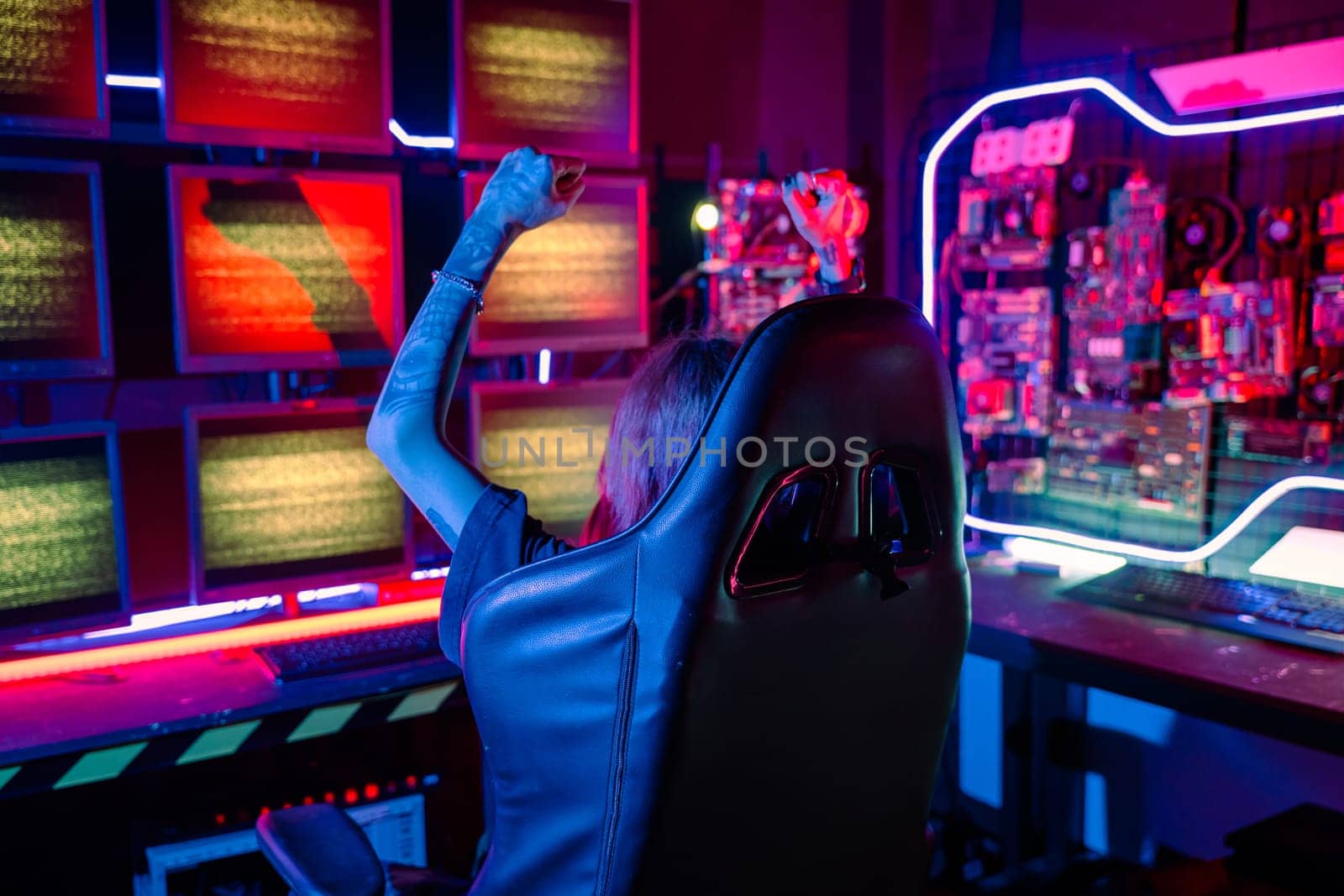 Winning. Happy Gamer young plays online video games computer she raises hands to wins tournament, young woman in gaming headphones playing video game online at home feel excited, E-Sport concept