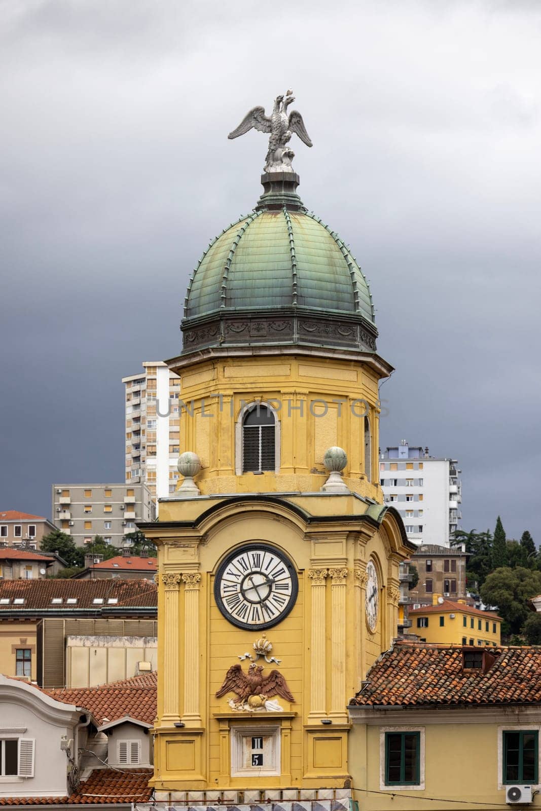 Rijeka, Croatia - September 23, 2023: Medieval baroque city clock tower ( Gradska ura) by Korzo promenade, main steet in the city. The tower is located above the city gate