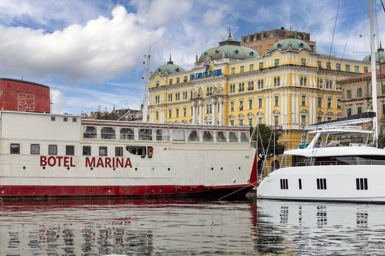 Rijeka, Croatia - September 23, 2023: Port of Rijeka with Adria Palace, decorative building seat of Jadrolinija, the ferry operator