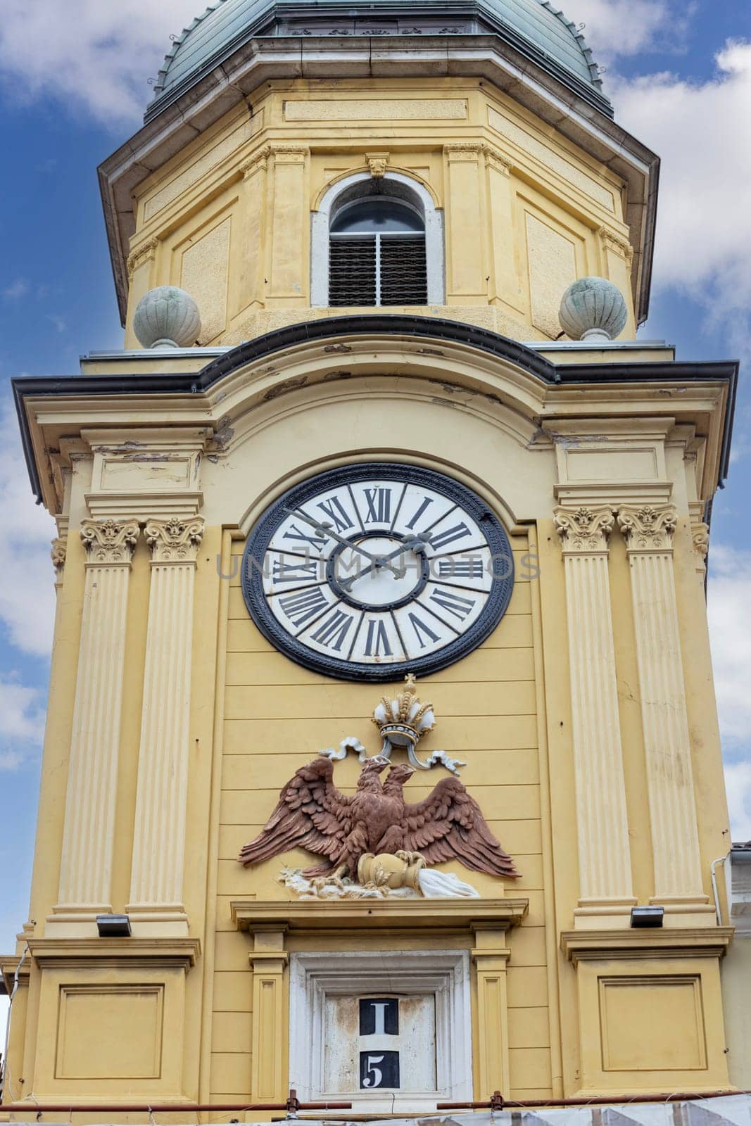 Rijeka, Croatia - September 23, 2023: Medieval baroque city clock tower ( Gradska ura) by Korzo promenade, main steet in the city. The tower is located above the city gate