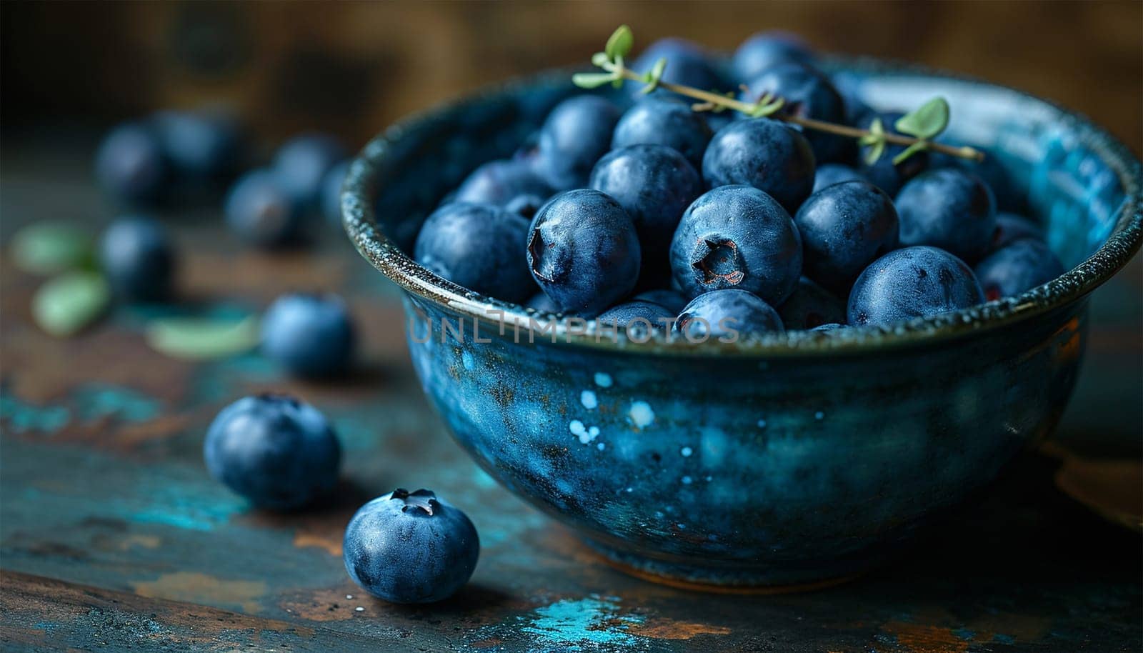 Freshly picked blueberries in blue bowl. Juicy and fresh blueberries with green leaves on rustic table. Bilberry on wooden Background. Blueberry antioxidant. Concept for healthy eating and nutrition Copy space