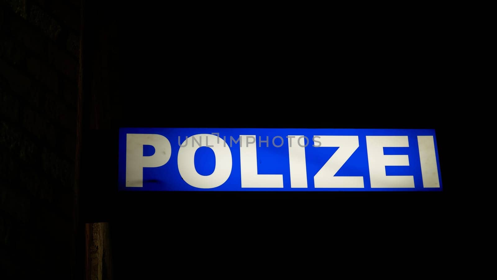 Neon light of a police station in the port of Stralsund in Germany at night