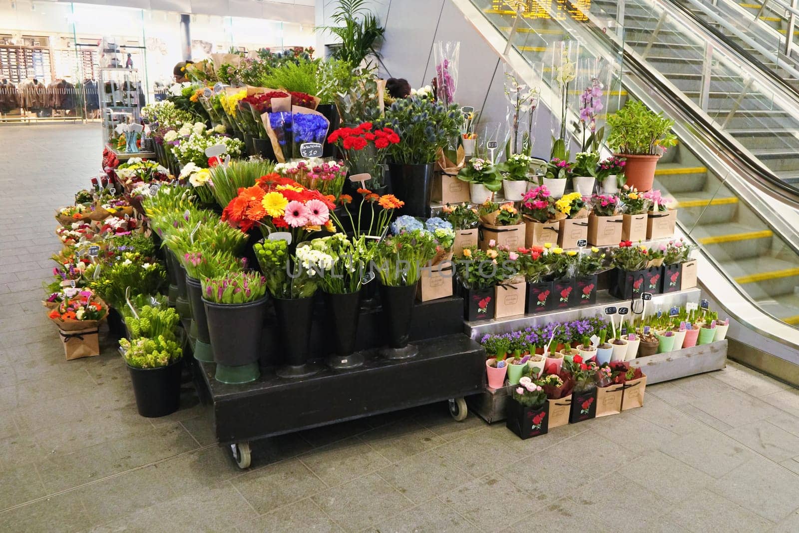London, United Kingdom - February 01, 2019: Flowers displayed at small florist inside London Bridge underground station. Flowershops are quite common at train or tube stations in UK capital