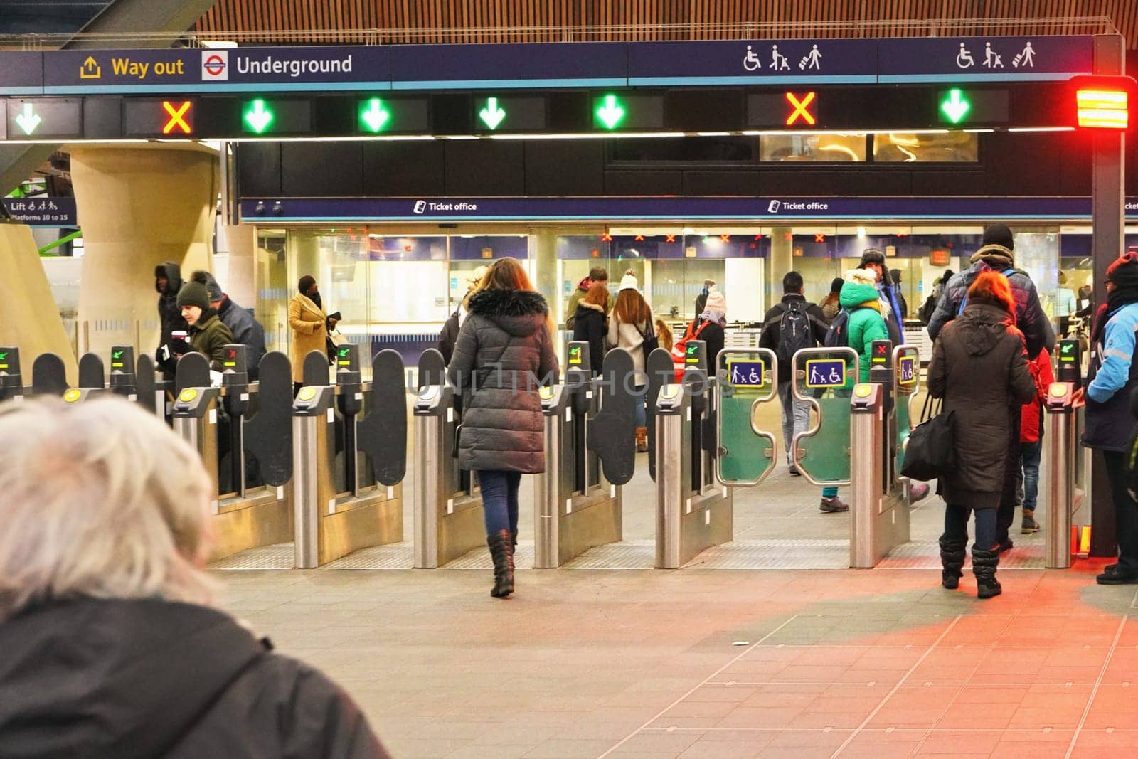 London, United Kingdom - February 01, 2019: People walking through turnstile at London Bridge underground station - 4th busiest in UK capital - ticket offices in background