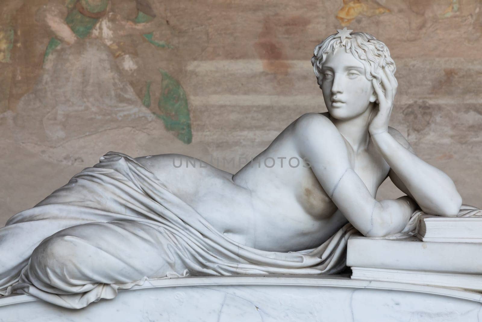 Pisa, Italy - 29 June 2023: sad statue in cemetery. Vintage white marble sculpture, woman sorrow