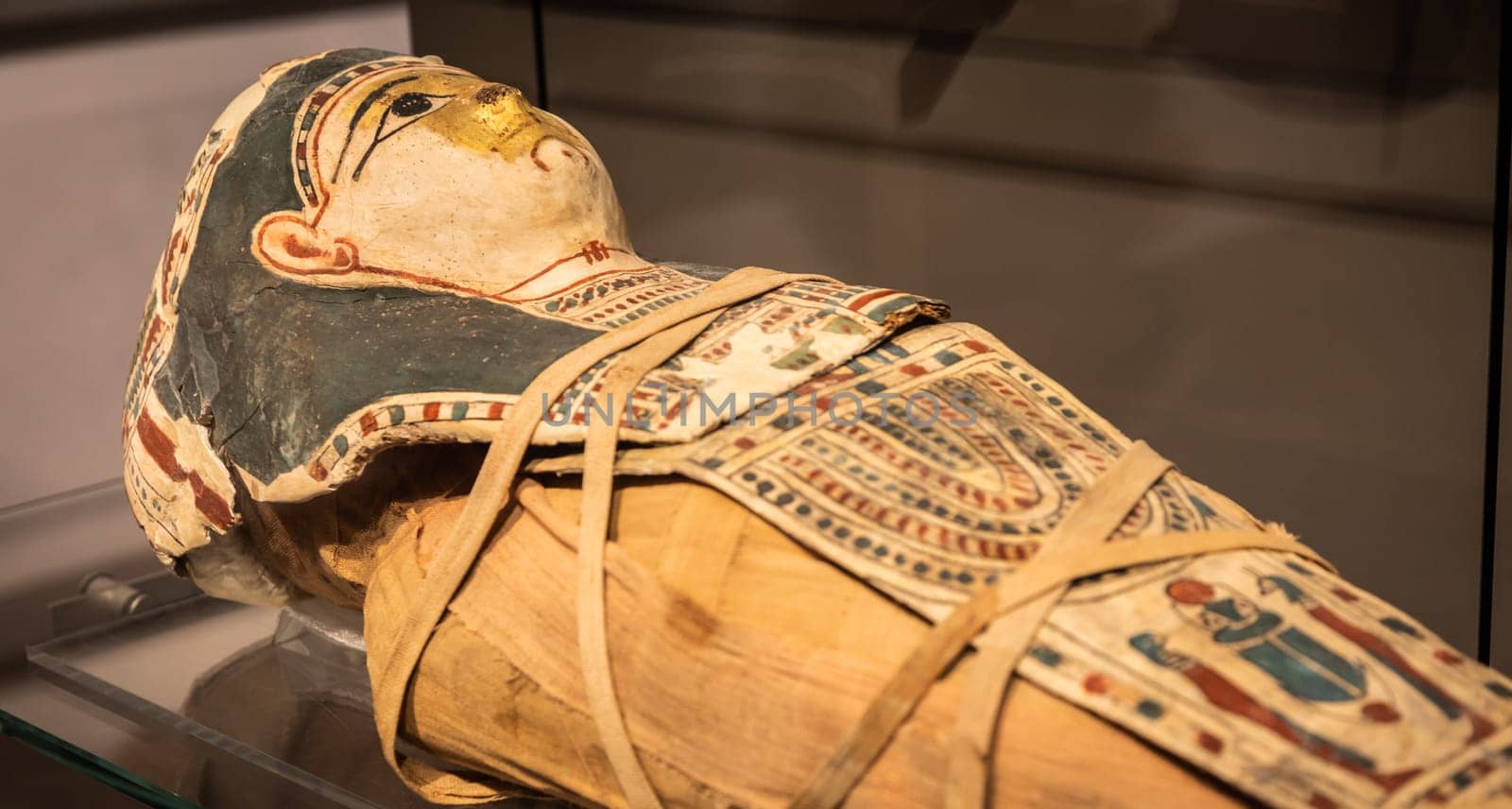 Turin, Italy - March 2023: Egyptian Museum, mummy of a baby with a mask - 2nd Century BC