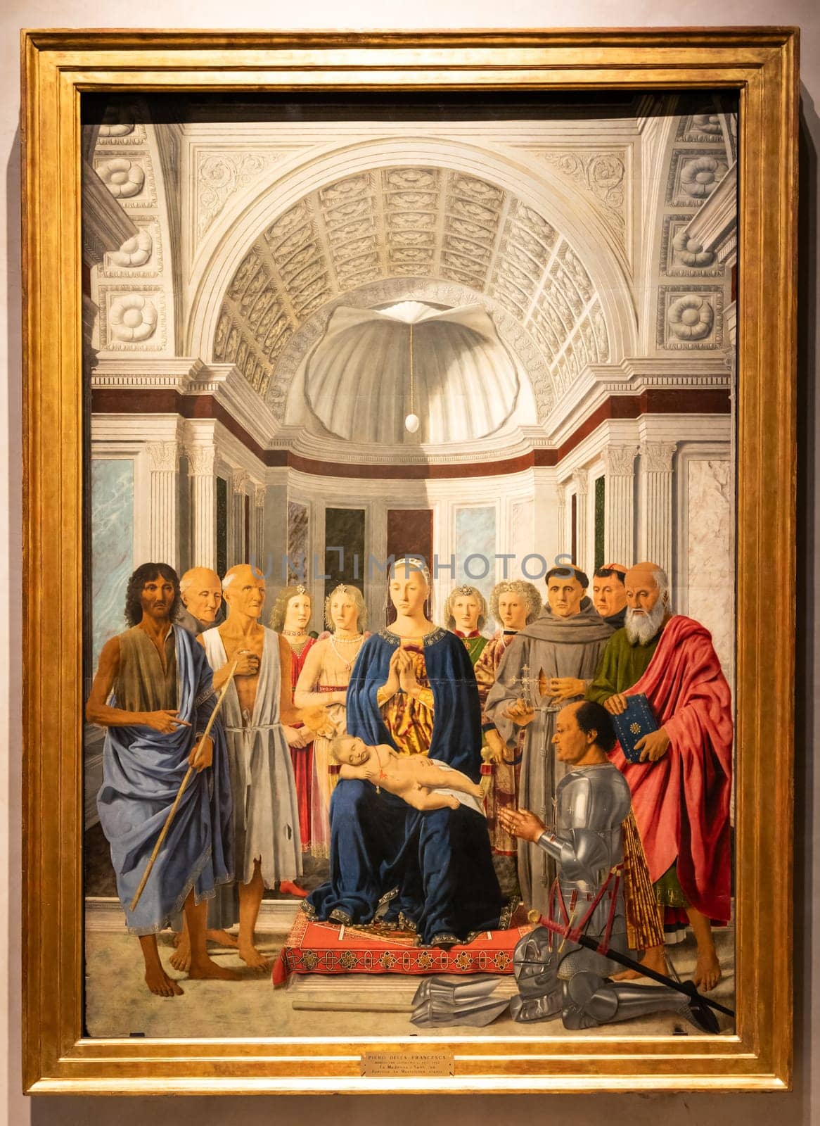 Milan, Italy - 23 September 2023: Brera antique painting museum. Madonna and child with saints, angels and Federico da Montefeltro, by painter Piero della Francesca, 1470